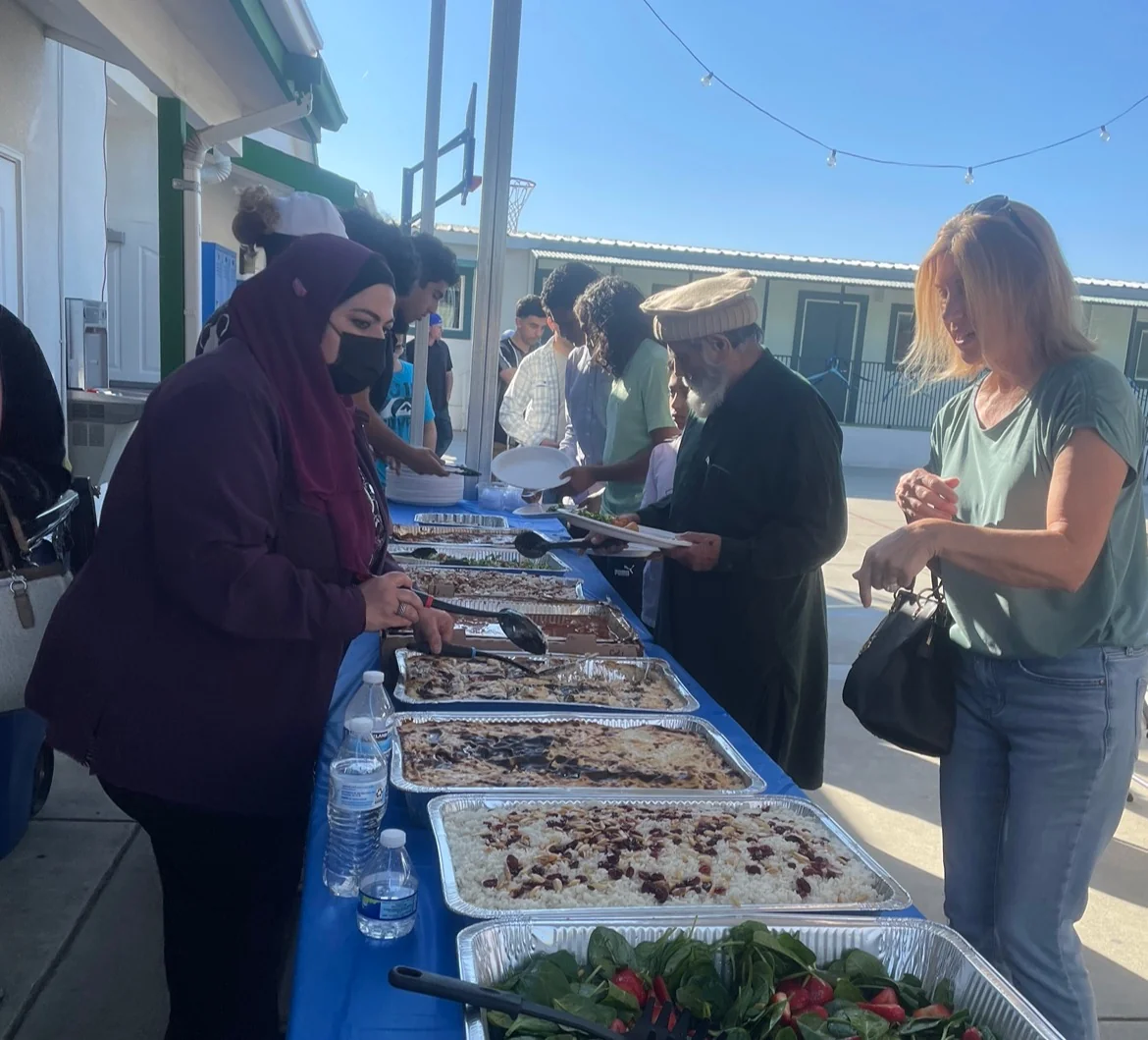 Guests lining up at a food table during a Legislative Lift community event